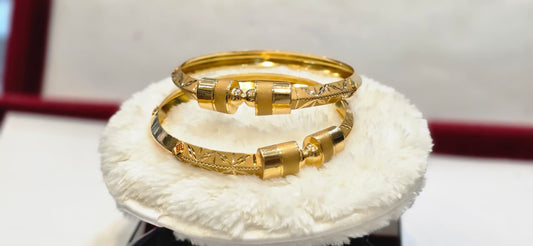 Gold Bangles with Auspicious Motifs and Stone Accents